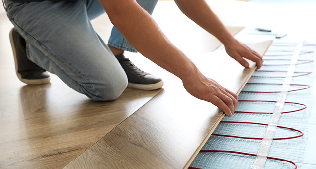 Man installing electric underfloor heating